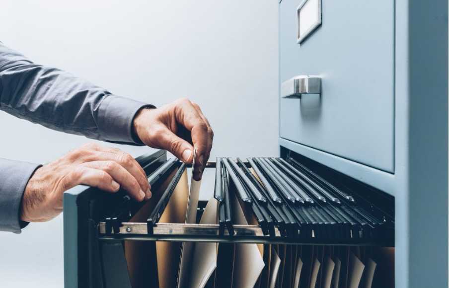 An office worker searching for someone's record of employment
